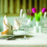Table setting with wine glasses and tulip flowers