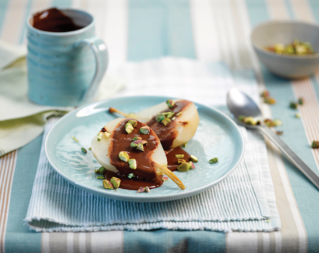 Poached pears with chocolate sauce & pistachios