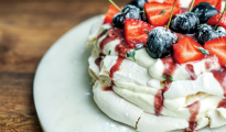 Vegan pavlova, with a boozy cherry sauce