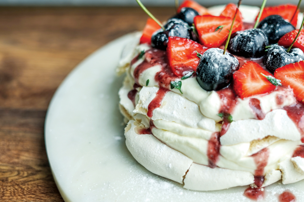 Vegan pavlova, with a boozy cherry sauce